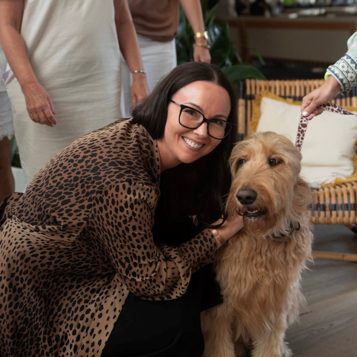Carla with a dog at a wellness event